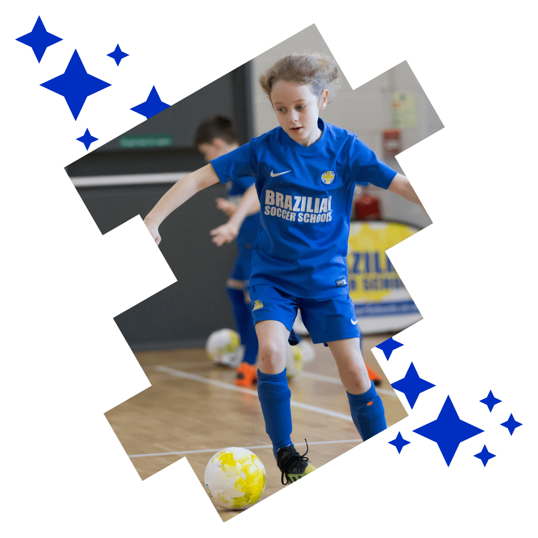 Girl controlling the football while playing at Brazilian Soccer Schools football training classes 